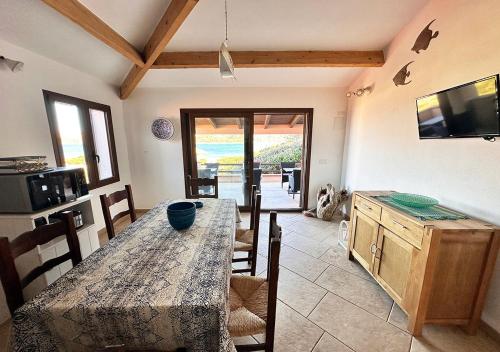 a dining room with a table and chairs and a television at Villa Iole in Casale Azara