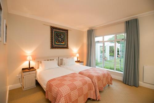 a bedroom with two beds and a window at Ocean House in Knysna