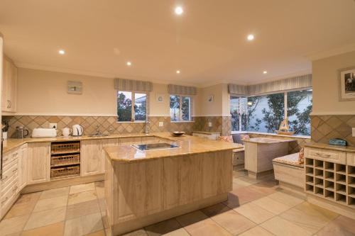 a large kitchen with a large island in the middle at Ocean House in Knysna