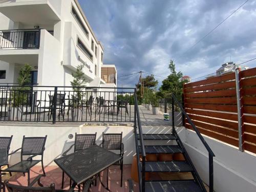 a balcony with chairs and tables on a building at Sunny Beach Potos in Potos
