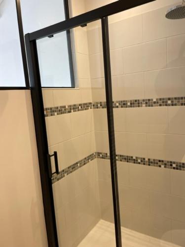 a shower with a glass door in a bathroom at Chez Catherine in Les Sables Vignier