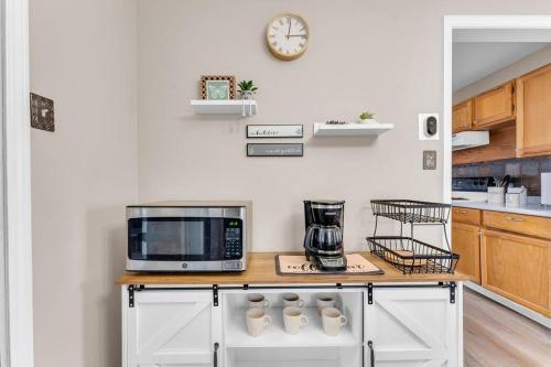 a kitchen with a counter top with a microwave at Central Falls Hideaway in Cuyahoga Falls