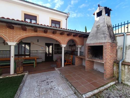 un patio al aire libre con un horno de pizza de ladrillo en Casa Alda, en Cabezuela