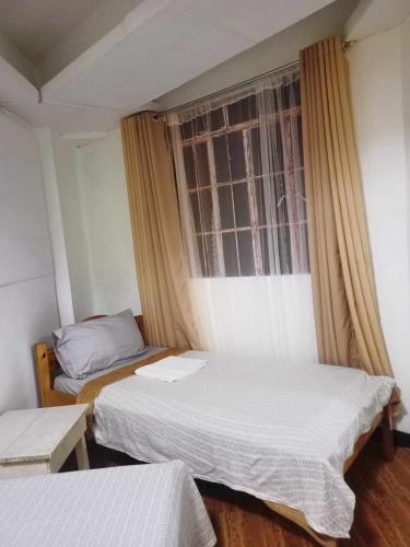 Ένα ή περισσότερα κρεβάτια σε δωμάτιο στο Pas-it Hostel Sagada
