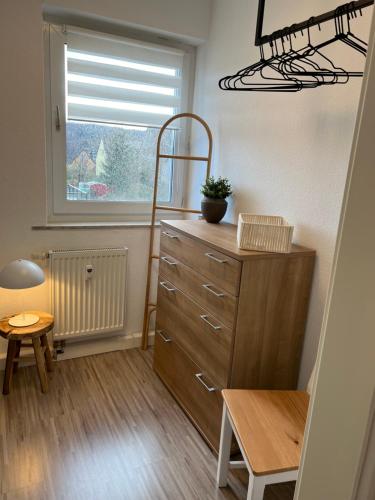 a small room with a dresser and a window at Nordic Charme by B&B in Bad Gandersheim