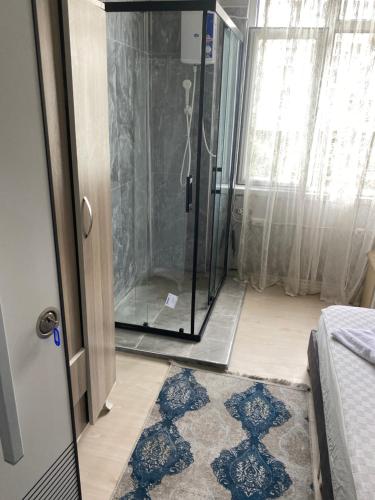 a shower in a room with a glass door at Red White House in Antalya
