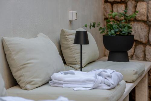 a couch with pillows and a blanket on a table at Apartment Barbara with Private pool in Dubrovnik