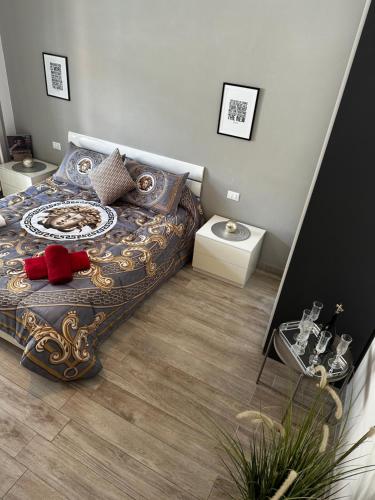 a bedroom with a large bed with a wooden floor at La Dimora degli Artisti in Pescara