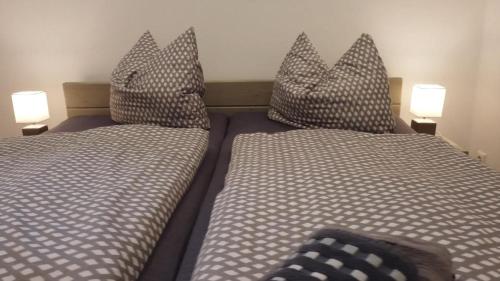 two beds with pillows sitting next to each other at Speicher-Appartement in Klein Upahl