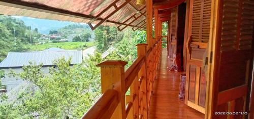 a balcony of a wooden house with a view at Higland Homestay Bac Ha in Bắc Hà