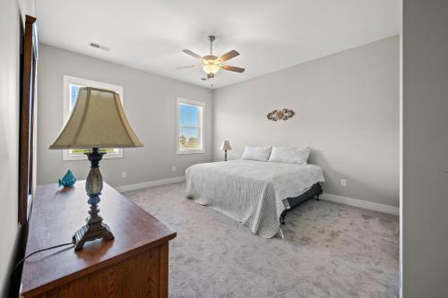 a bedroom with a bed and a table with a lamp at North Myrtle Beach Home - Walk to the Ocean! in Myrtle Beach