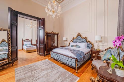 a bedroom with a king sized bed and a chandelier at Ring Stone Hotels Old City in Istanbul