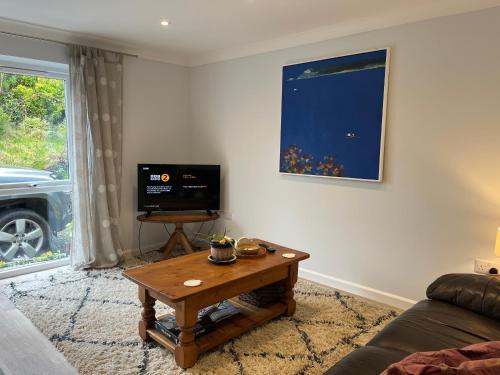 a living room with a coffee table and a tv at The Hannexe in Wadebridge