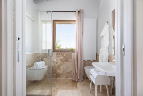 a bathroom with a sink and a tub and a toilet at Villa Velari In Volterra With Private Pool, AC in Volterra