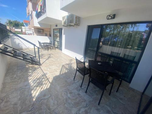a balcony with a table and chairs on a patio at Sunny Beach Potos in Potos