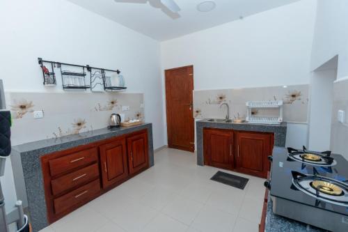 a kitchen with a sink and a stove at The Islands Breeze Villa in Dehiwala
