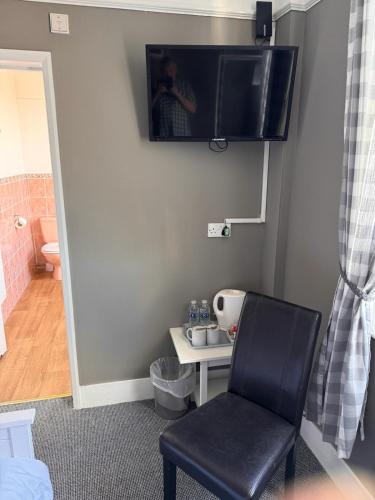 a person taking a picture of a chair in a room at Waterfront Hotel in Deal