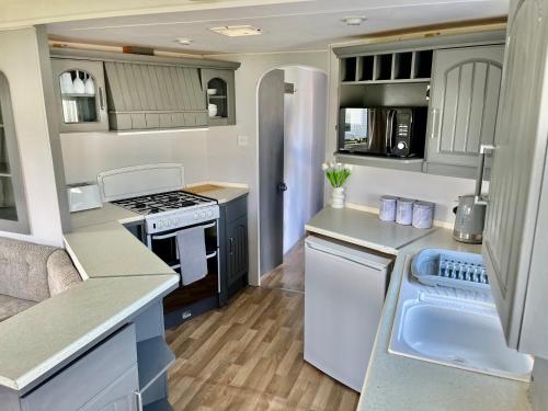 an rv kitchen with a stove and a refrigerator at Sand Le Mere E11 in Beverley