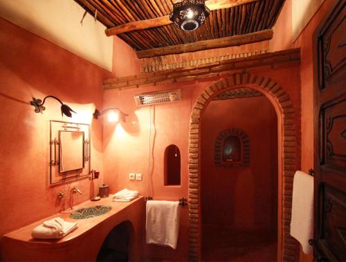 a bathroom with a sink and a mirror at Riad Palmier in Marrakech