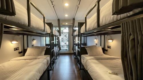 a row of bunk beds in a room at THE BOSS HOTEL CHIANGMAl in Chiang Mai