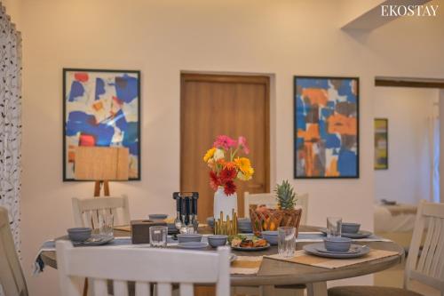 a dining room with a table with chairs and a dining room at EKOSTAY - Aqua Villa in Alibaug