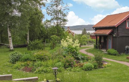 a garden in front of a log cabin at Beautiful Home In Leksand With Wifi in Leksand