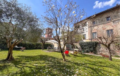 a grassy yard with trees and a building at 1 Bedroom Nice Home In Sansepolcro in Sansepolcro