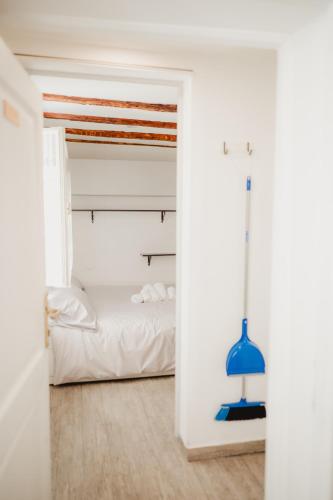 a bedroom with a bed and a blue lamp at Monolocale Marina in centro storico in Trieste