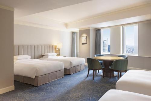 a hotel room with two beds and a table at Nagoya Marriott Associa Hotel in Nagoya