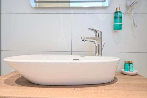 a white sink on a wooden counter in a bathroom at Šangulin Palace V in Biograd na Moru