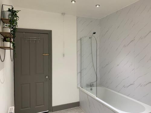 a bathroom with a shower and a bath tub at Rectory4 -Lovely 4 Bdrm 6 Beds Gateshead Free Parking in Gateshead