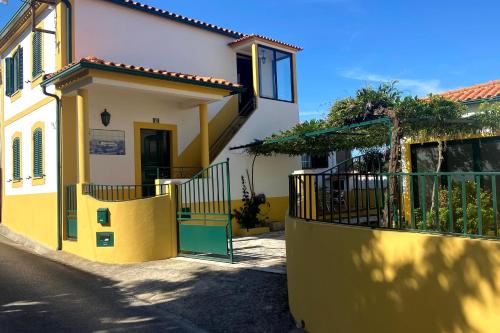 a yellow and white house with a gate at Casa da Luz - Country House with Terrace in Semide