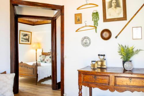 a room with a wooden dresser and a bedroom at Casa da Luz - Country House with Terrace in Semide
