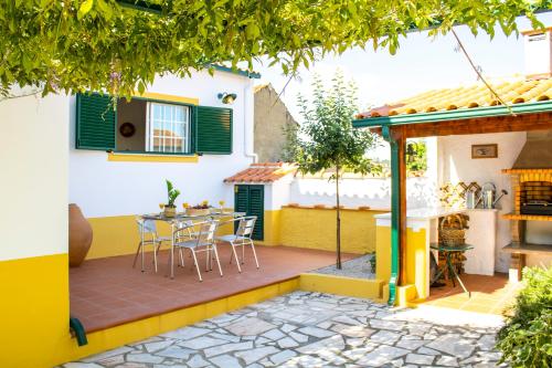 a patio in a house with a table and chairs at Casa da Luz - Country House with Terrace in Semide