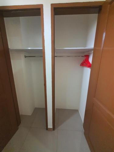 an empty closet with a red object in it at MB Apartments & Hotel Medan in Sunggal