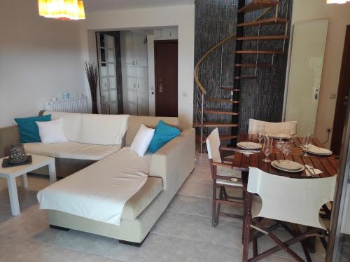 a living room with a couch and a table at Villa La Bella Vista in Skála Foúrkas