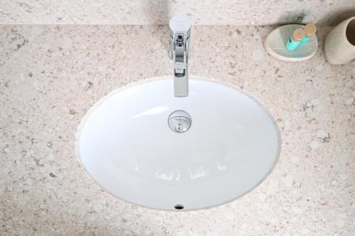 a white sink in a bathroom with a floor at Šangulin Palace V in Biograd na Moru