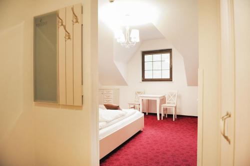 a small room with a bed and a table at Malutkie Resort in Radomsko