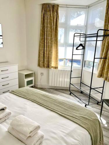 a bedroom with a bed and a window at Luton flat with parking in Luton