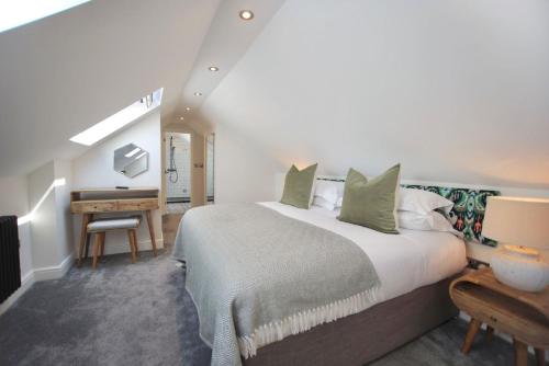 a bedroom with a large bed and a desk at Paddock View in Osmotherley