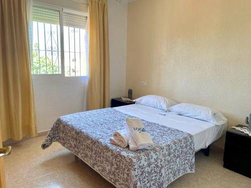 a bedroom with a bed with two towels on it at Estudios privados en villa con piscina privada in Els Poblets