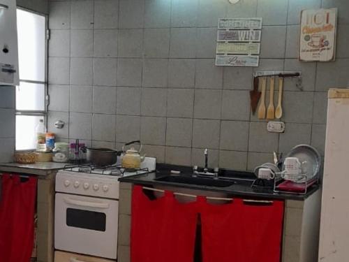 a kitchen with a sink and a stove top oven at Cafaro in San Miguel de Tucumán