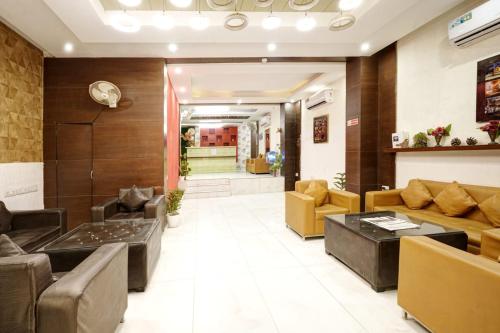 a lobby of a hospital with couches and chairs at Hotel Claytone Near Delhi Airport in New Delhi