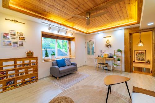 a living room with a chair and a table at I'm Green Stay in Seoul