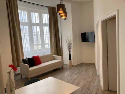 a living room with a couch and a window at Top Wenceslas Square Apartment in Prague