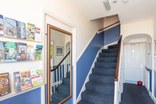 a staircase in a house with blue walls and blue carpet at The Kings Head in Deal