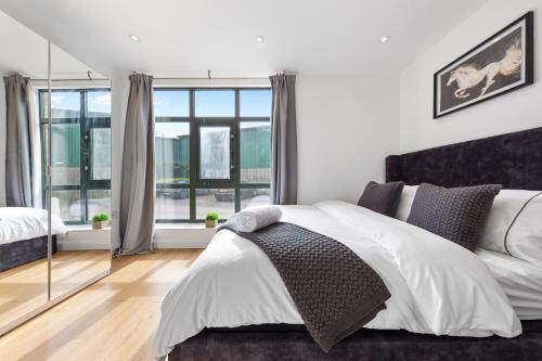 a bedroom with a bed and a large window at Apartment in Hertfordshire in Hemel Hempstead