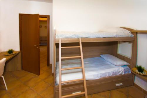 a room with two bunk beds with a ladder at Residence Delle Rose in Tremosine Sul Garda