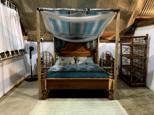 a bunk bed with a canopy in a room at Pongwe Eco Lodge and kitten paradise. in Mdudu Mdogo