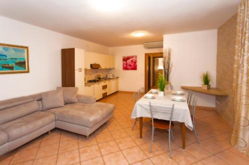 a living room with a couch and a table at Residence Delle Rose in Tremosine Sul Garda